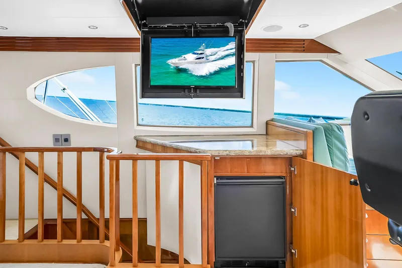 Slide: The Image of Luxurious interior of 2008 Hatteras 77 Convertible yacht with ocean view and TV. - 91