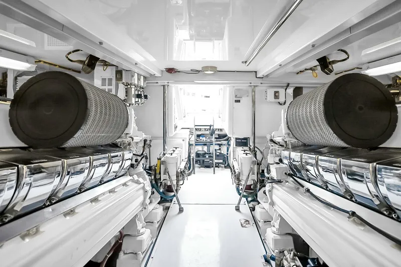 Slide: The Image of Engine room of 2008 Hatteras 77 Convertible yacht, showcasing dual engines and mechanical systems. - 96