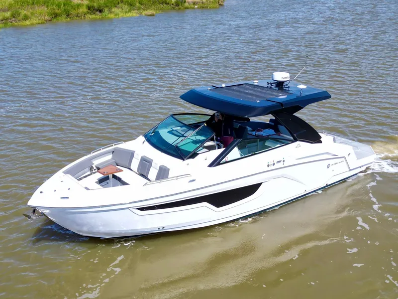 The Image of 2023 Cruisers Yachts 34 GLS I/O boat cruising on a calm river. - 0