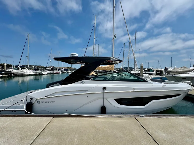 Slide: The Image of 2023 Cruisers Yachts 34 GLS I/O docked at a marina under a clear sky. - 11