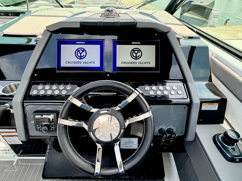 Slide: The Image of 2023 Cruisers Yachts 34 GLS I/O helm with dual displays and modern controls. - 31
