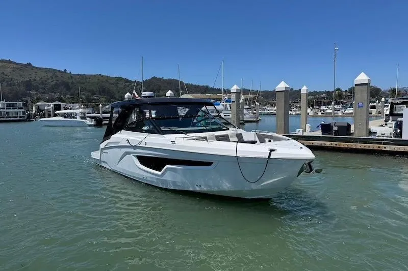 Slide: The Image of 2023 Cruisers Yachts 34 GLS I/O in marina, sleek design, sunny day. - 4