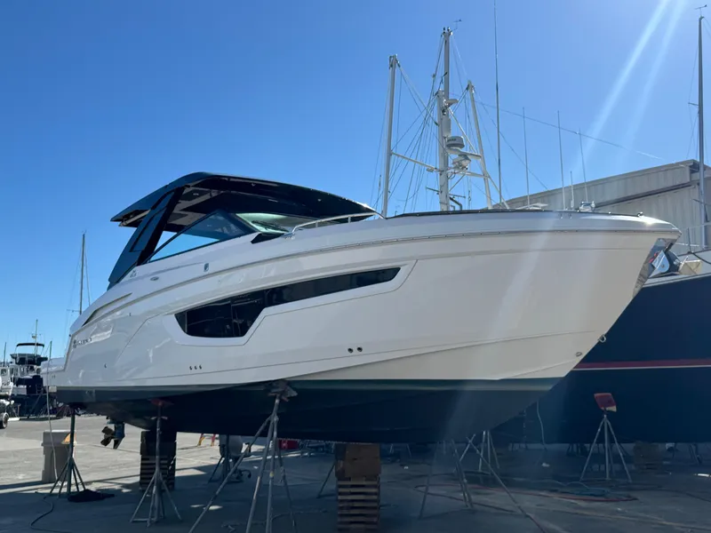 Slide: The Image of 2023 Cruisers Yachts 34 GLS I/O boat on stands in a marina setting. - 70