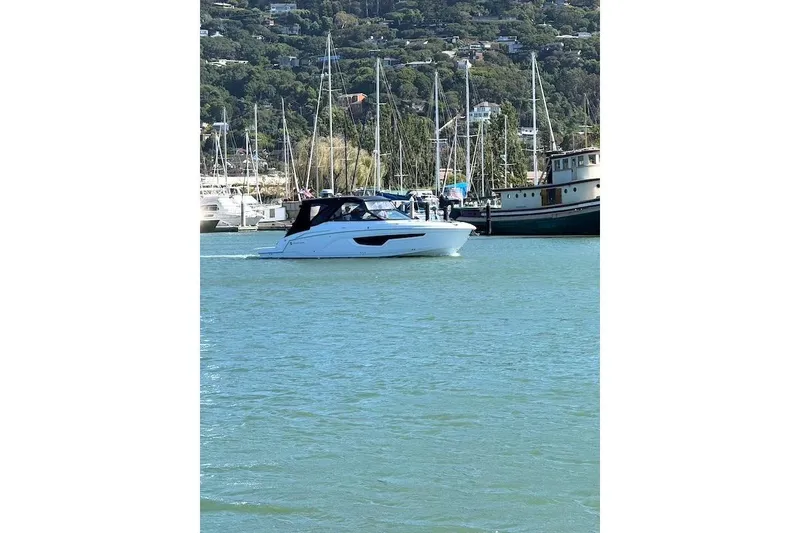 Slide: The Image of 2023 Cruisers Yachts 34 GLS I/O on serene water near marina. - 77