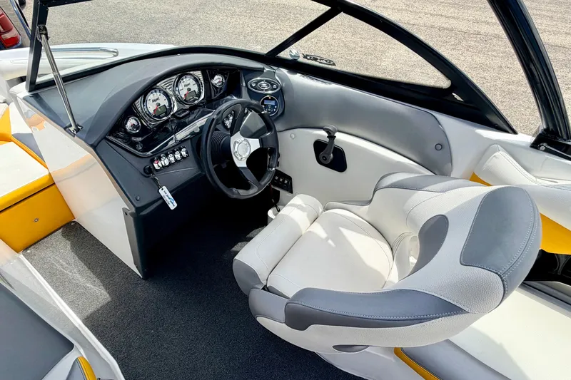 Slide: The Image of Interior of a 2014 Tigé R20 boat featuring a sleek dashboard and comfortable seating. - 45