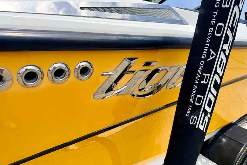 Slide: The Image of Close-up of 2014 Tigé R20 boat with yellow hull and chrome logo. - 14