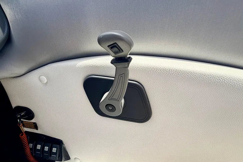 Slide: The Image of Interior handle of a 2014 Tigé R20 boat, featuring textured white upholstery. - 50