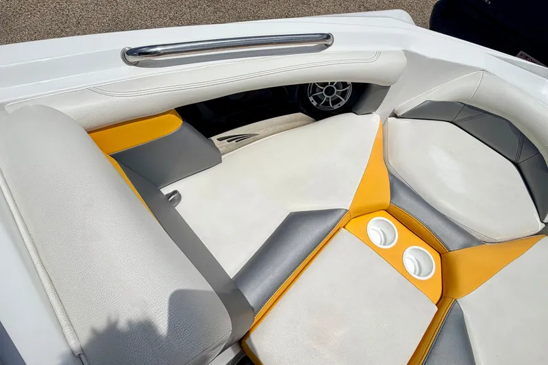 Slide: The Image of Interior of 2014 Tigé R20 boat with white and yellow seating, featuring cup holders. - 56