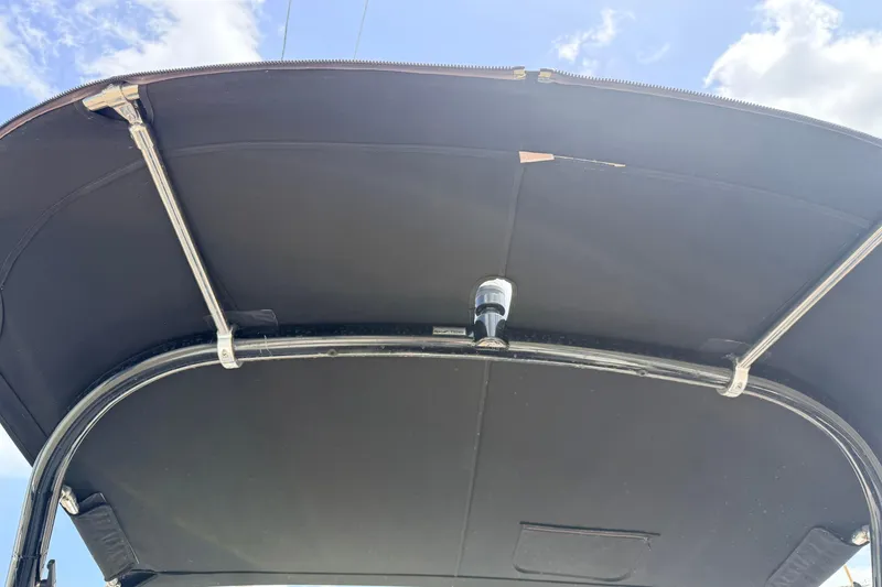 Slide: The Image of 2014 Tigé R20 boat canopy with metal frame under a blue sky. - 68