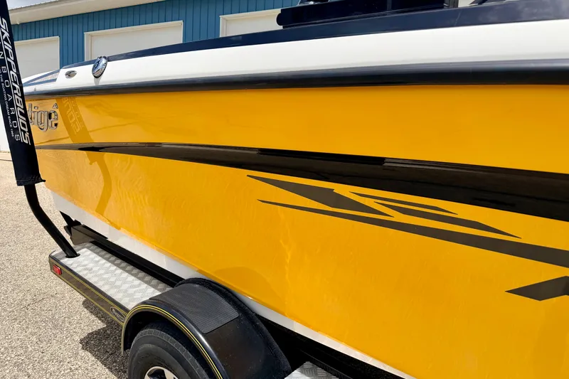 Slide: The Image of 2014 Tigé R20 boat with vibrant yellow exterior and sleek black accents. - 13