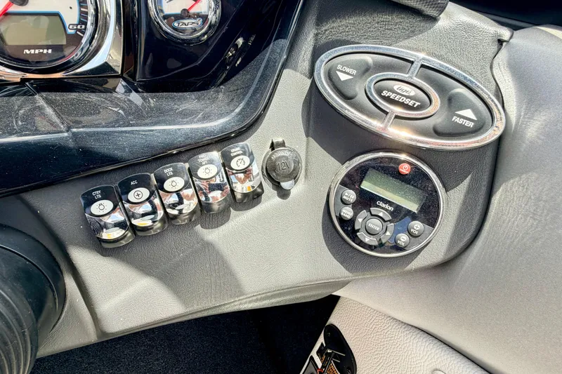 Slide: The Image of Dashboard controls of a 2014 Tigé R20 boat, featuring gauges and switches. - 49