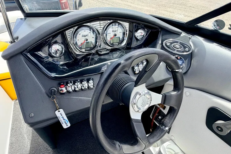 Slide: The Image of 2014 Tigé R20 boat dashboard with steering wheel and control panel. - 46