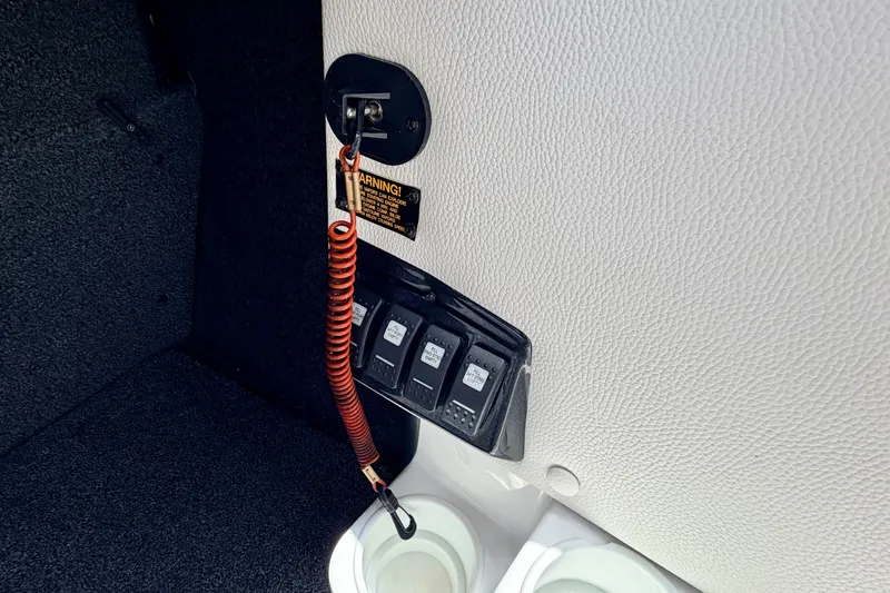 Slide: The Image of 2014 Tigé R20 boat interior with safety lanyard and control switches. - 51