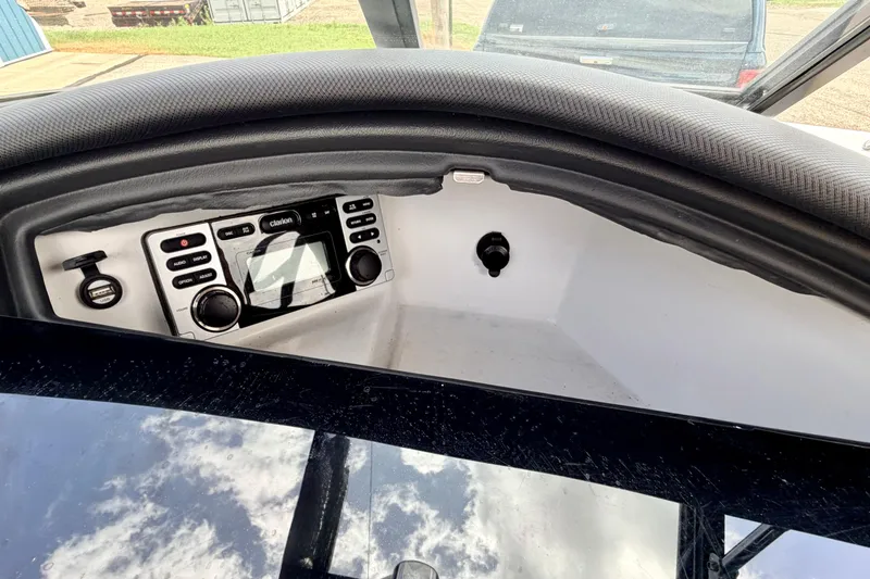 Slide: The Image of 2014 Tigé R20 boat dashboard with Clarion audio system and control panel. - 44