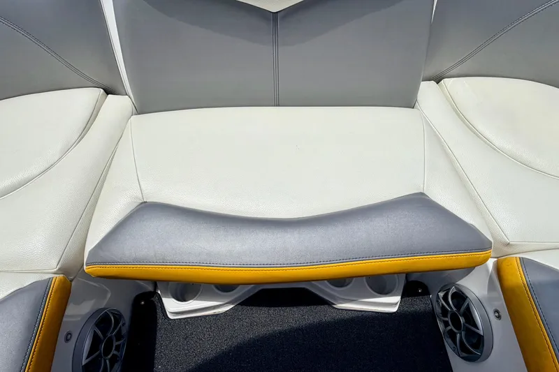 Slide: The Image of 2014 Tigé R20 boat interior seating with gray and yellow accents, featuring built-in speakers. - 36