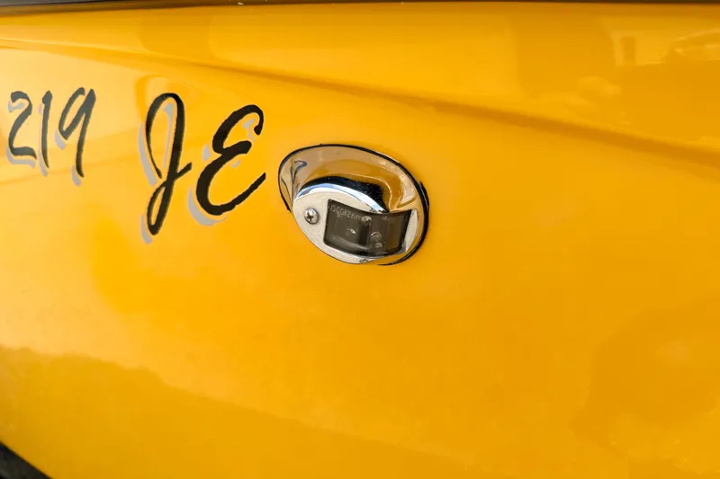 Slide: The Image of Close-up of a yellow 2014 Tigé R20 boat with chrome detailing and lettering. - 79