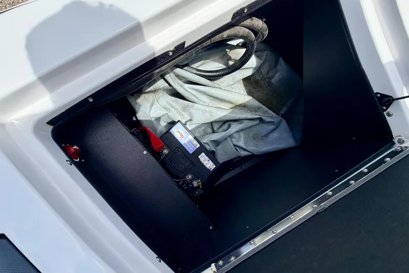 Slide: The Image of A storage compartment in the boat with a cover and battery compartment. - 27