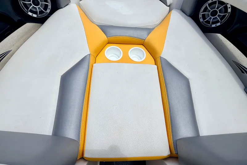 Slide: The Image of 2014 Tigé R20 boat interior with gray and yellow upholstery, featuring dual cup holders. - 58