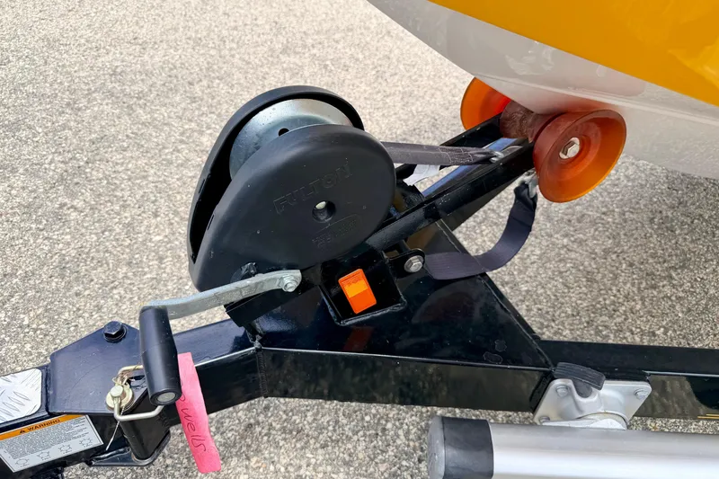 Slide: The Image of Trailer hitch and winch system for 2014 Tigé R20 boat, featuring orange rollers. - 77