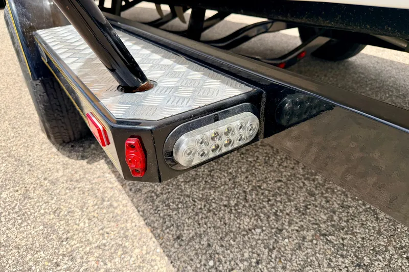 Slide: The Image of Trailer light and step detail on a 2014 Tigé R20 boat trailer. - 83
