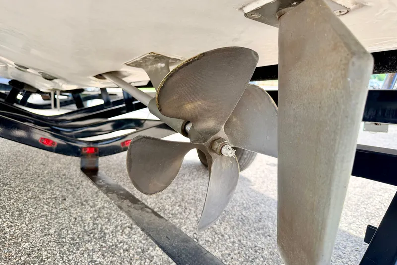 Slide: The Image of Close-up of a 2014 Tigé R20 boat propeller and rudder on a trailer. - 21