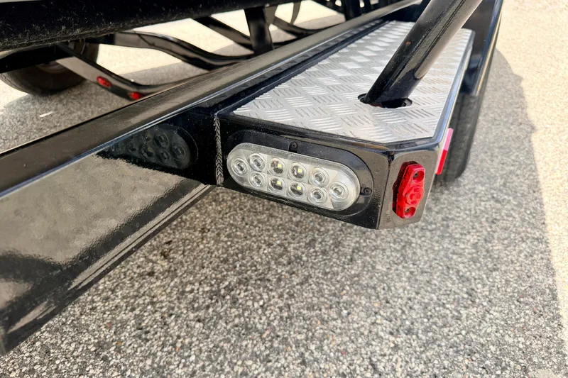Slide: The Image of Close-up of 2014 Tigé R20 trailer light and step detail on asphalt. - 82