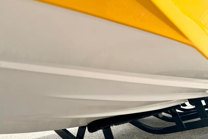 Slide: The Image of Close-up of 2014 Tigé R20 boat hull with yellow and white design. - 74