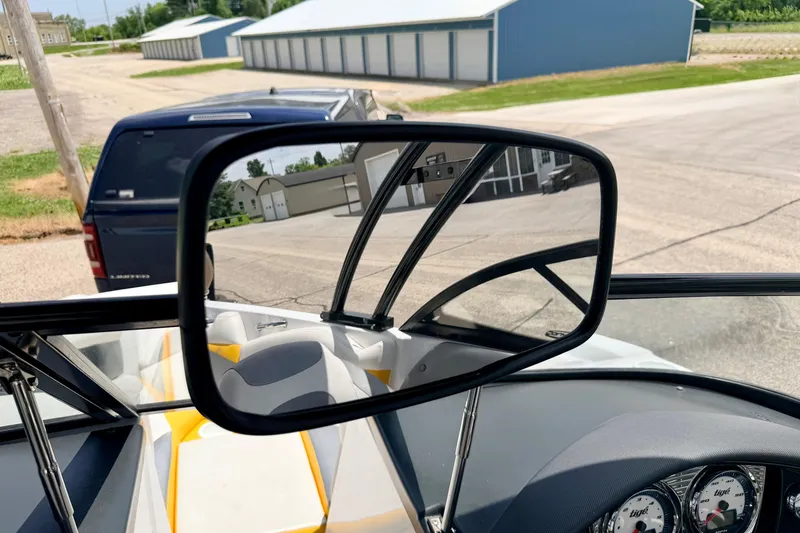 Slide: The Image of 2014 Tigé R20 boat interior with rearview mirror and dashboard gauges. - 67