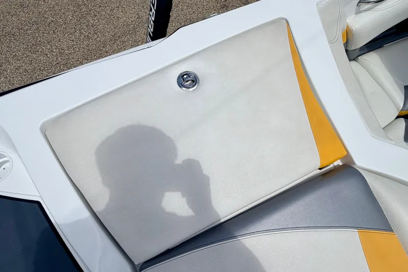 Slide: The Image of 2014 Tigé R20 boat seat with yellow accents and shadow on upholstery. - 26