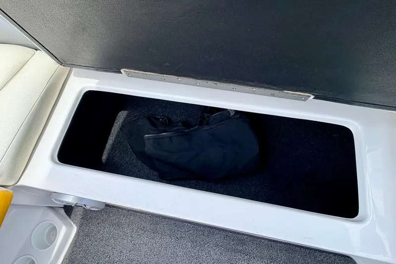 Slide: The Image of Storage compartment in 2014 Tigé R20 boat with black bag inside. - 39