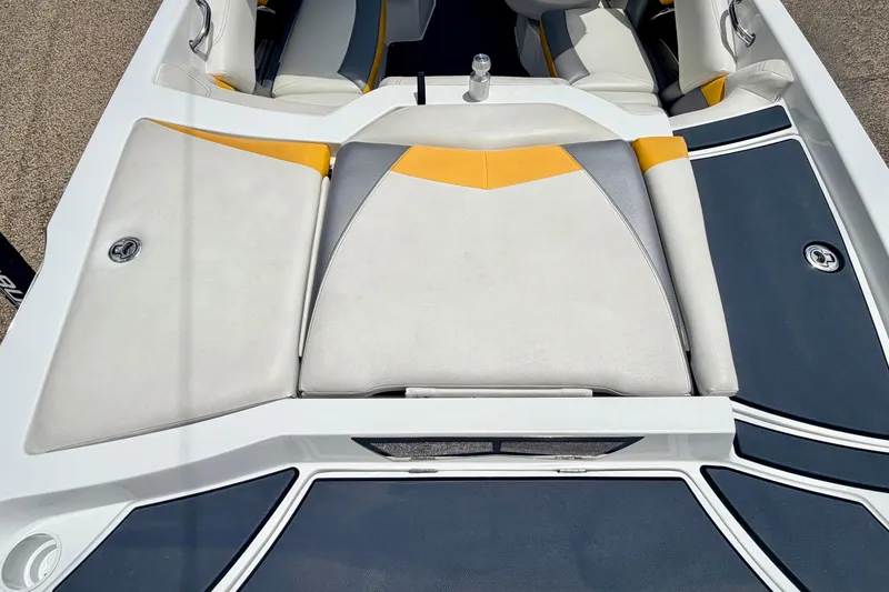 Slide: The Image of 2014 Tigé R20 boat interior with white, yellow, and gray seating. - 23
