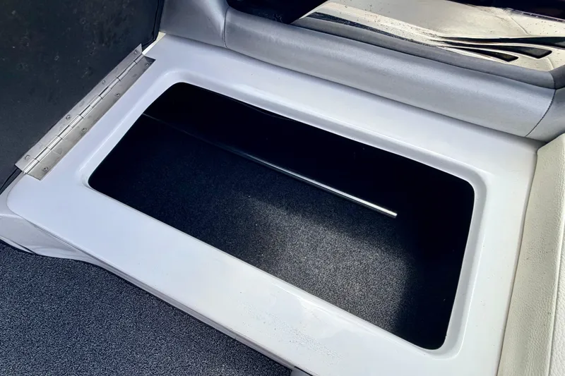 Slide: The Image of 2014 Tigé R20 boat storage compartment with open lid, showcasing interior space. - 33