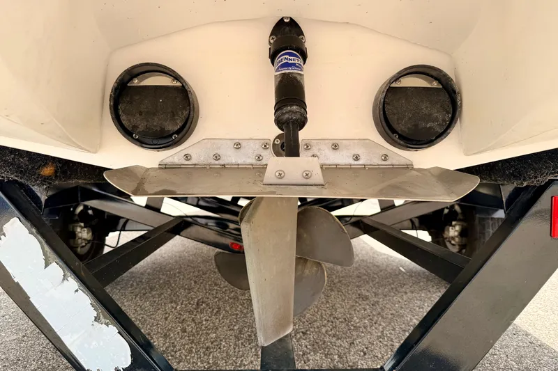 Slide: The Image of 2014 Tigé R20 boat propeller and trim tab detail on trailer. - 20