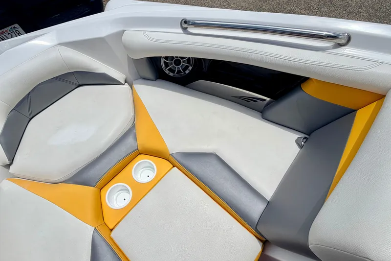 Slide: The Image of 2014 Tigé R20 boat interior with white, yellow, and gray seating and cup holders. - 57