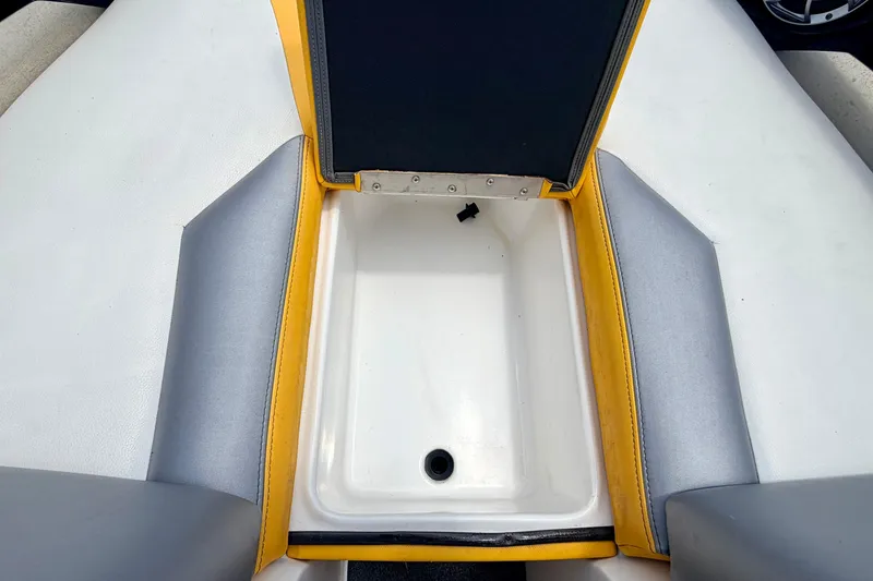 Slide: The Image of Open storage compartment in 2014 Tigé R20 boat with yellow and gray upholstery. - 59