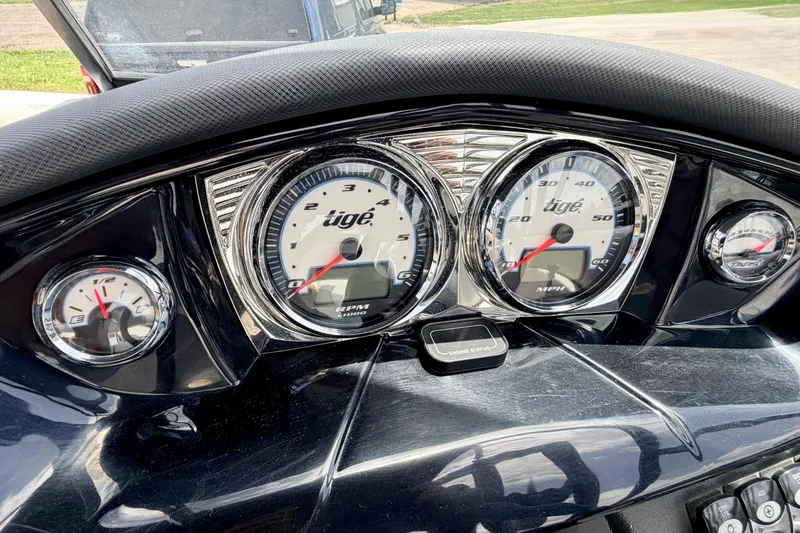 Slide: The Image of Dashboard of a 2014 Tigé R20 boat with speedometer and tachometer gauges. - 47