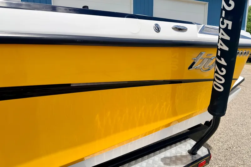 Slide: The Image of 2014 Tigé R20 boat with vibrant yellow hull and sleek design. - 15