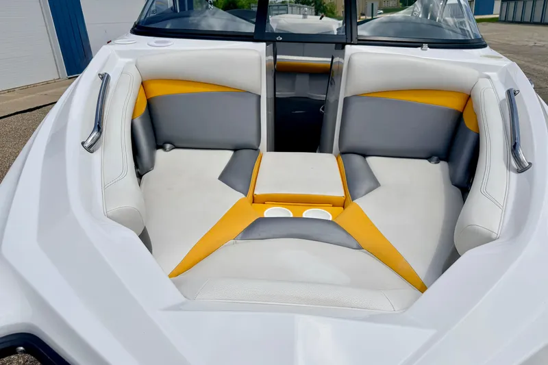 Slide: The Image of 2014 Tigé R20 boat interior with white, gray, and yellow seating, featuring cup holders. - 78