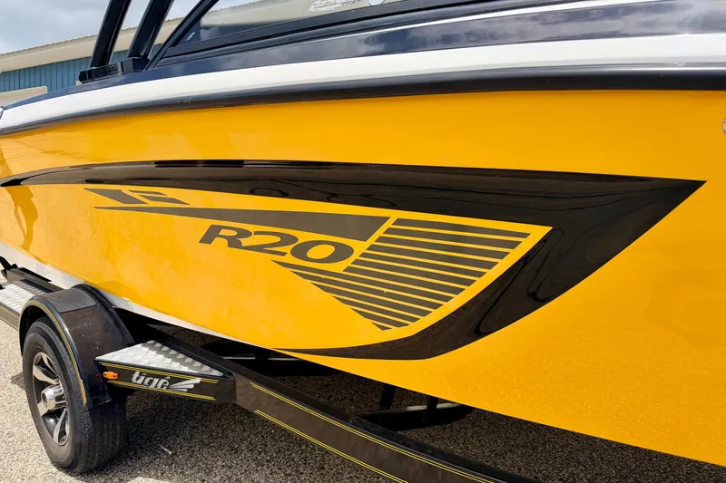 Slide: The Image of 2014 Tigé R20 boat in vibrant yellow with black detailing on trailer. - 9