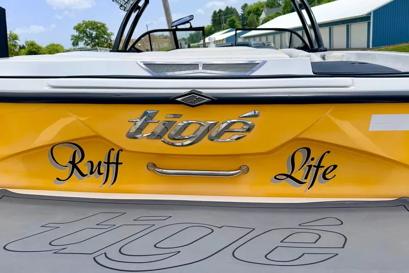 Slide: The Image of 2014 Tigé R20 boat with "Ruff Life" decal on yellow hull. - 16