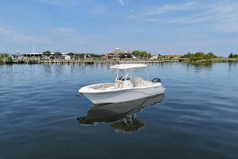 The Image of 2022 Sea Fox 248 Commander boat on calm water near a marina. - 0