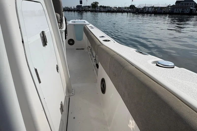 Slide: The Image of 2022 Sea Fox 248 Commander boat interior with cushioned seating and water view. - 11