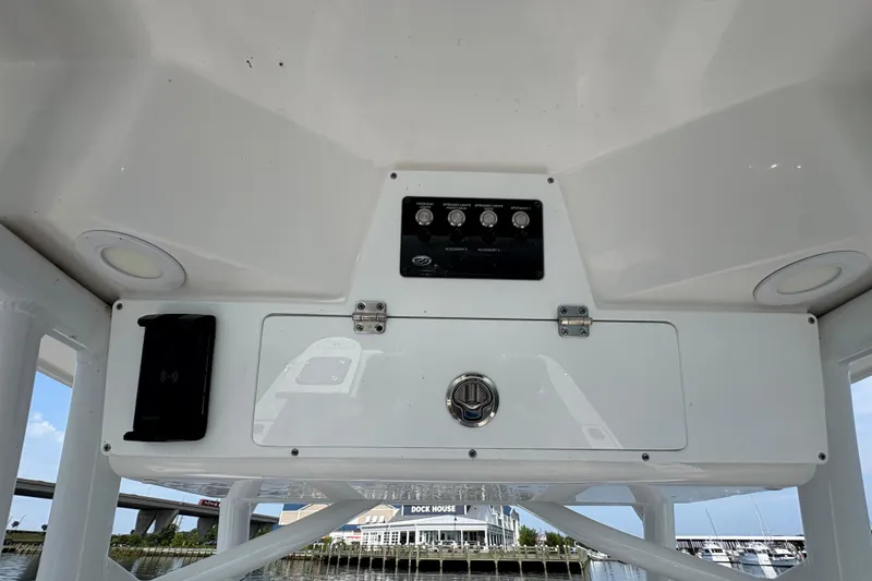 Slide: The Image of 2022 Sea Fox 248 Commander boat console with controls and storage compartment. - 15