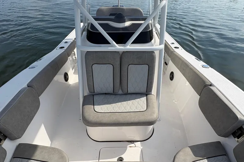 Slide: The Image of 2022 Sea Fox 248 Commander boat interior with cushioned seating and sleek design on water. - 6