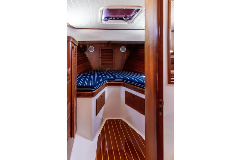Slide: The Image of Interior cabin of 2000 Hinckley Picnic Boat 36 Classic with striped cushions and wood finish. - 15