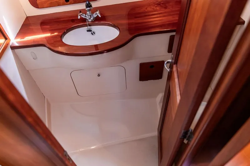Slide: The Image of Hinckley Picnic Boat 36 Classic 2000 bathroom with wooden vanity and sink. - 18