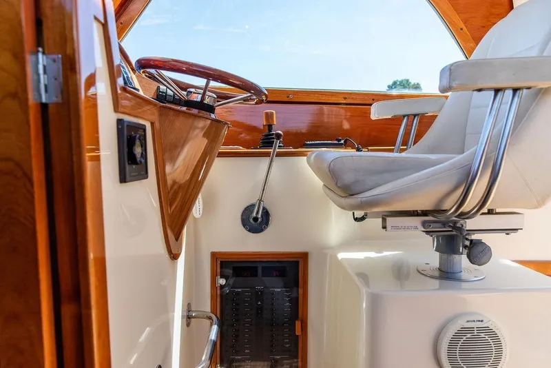 Slide: The Image of Interior helm of 2000 Hinckley Picnic Boat 36 Classic with steering wheel and captain's chair. - 6