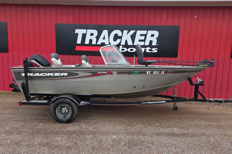 Slide: The Image of 2005 Tracker Pro Guide V-16 WT boat on trailer, displayed outdoors. - 4