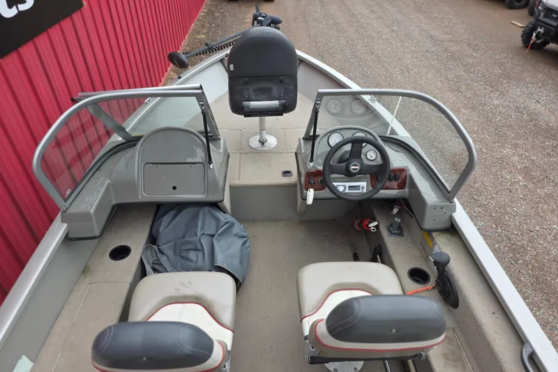 Slide: The Image of 2005 Tracker Pro Guide V-16 WT boat interior with steering wheel and seating. - 9