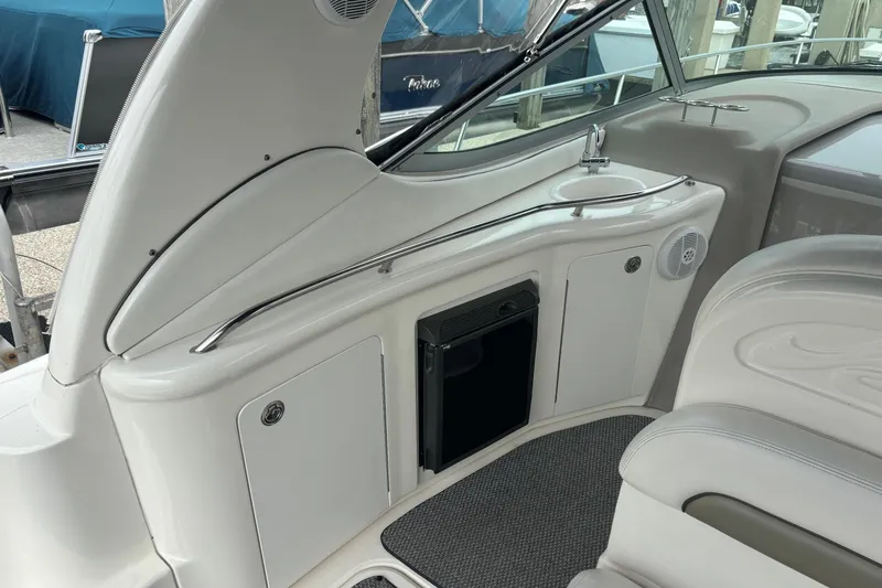 Slide: The Image of 2006 Sea Ray 300 Sundancer interior with sink, storage, and seating area. - 13